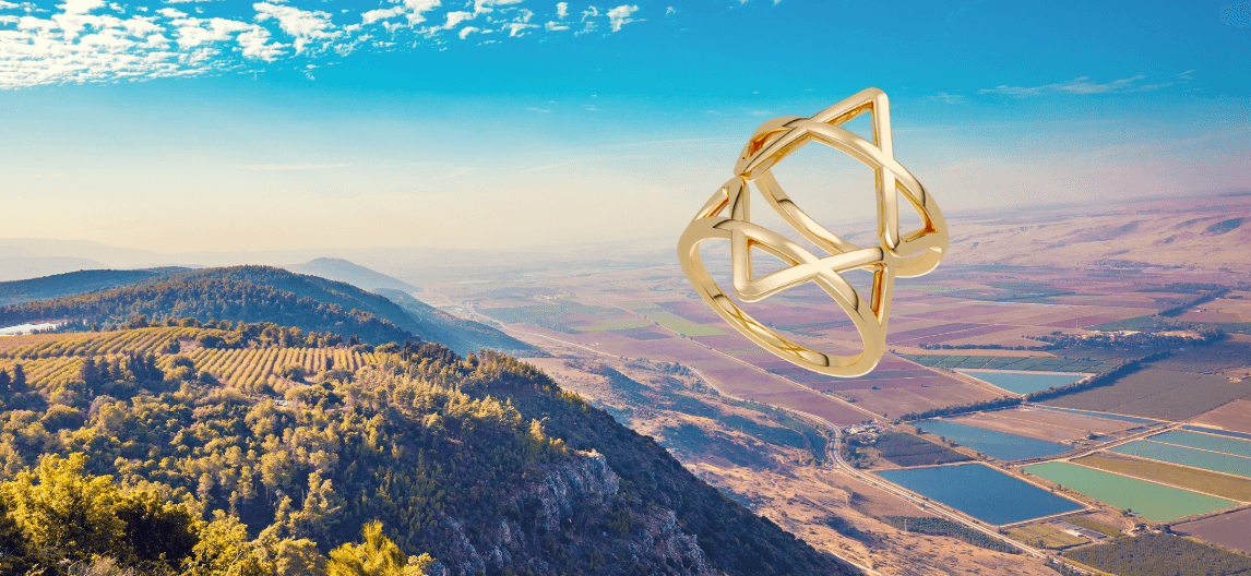 Composite image of the gold vermeil Star of David Ring above a landscape of valleys and fields in northern Israel.